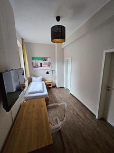 a living room with a couch and a tv at Hotel Friedensbruecke in Greiz