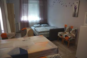 a small room with a bed and a table and chairs at Villa La Vita in Hévíz +61 photos