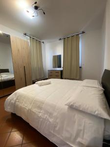 a bedroom with a large white bed in a room at Host San Pietro in Formigine +14 photos