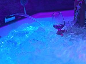 a glass of wine sitting in a hot tub at Samamà House in Taranto