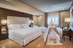 A bed or beds in a room at Barceló Granada Congress