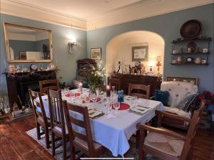 a dining room with a table with wine glasses at The Old Rectory in Stewartstown