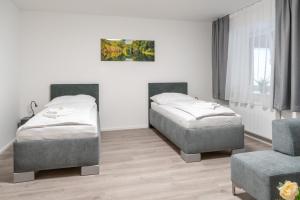 Posteľ alebo postele v izbe v ubytovaní Apartmány LAGUNA