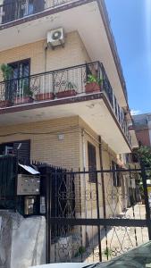 a building with an iron gate and a balcony at La casa di Amina in Rome +3 photos