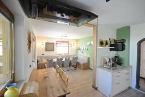 a dining room and living room with a wooden table at Green Hammer in Tschagguns
