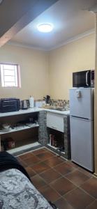 a kitchen with a white refrigerator and a sink at Prieska Kokerrus in Prieska +4 photos