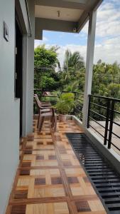 a balcony with a chair and a view of the ocean at Rocky Homestay in Hampi +29 photos