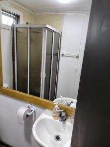 a bathroom with a sink and a mirror at Maravilloso vista al estrecho in Punta Arenas