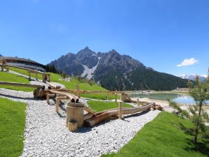 a park with a lake and mountains in the background at Apartment in Mieders near Ski Lift in Mieders +22 photos