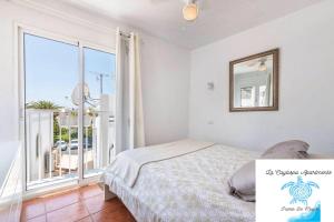 a bedroom with a bed and a large window at La Caytispa in Puerto de Mogán