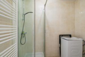 a shower with a glass door next to a toilet at Chez Virgil - Terrasse vue dégagée, parking privé in Ernolsheim-Bruche +18 photos