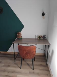 a desk with a chair and a table with a wall at La grange aux animaux in Tollevast +18 photos