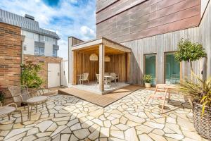 a patio with a table and chairs and a building at Boutique Hotel Copper & Co in Middelburg