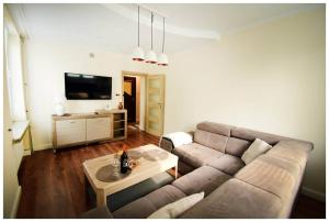 a living room with a couch and a table at Color 24 Apartament Relaks in Stalowa Wola