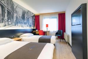 Postel nebo postele na pokoji v ubytování Bastion Hotel Bussum Hilversum