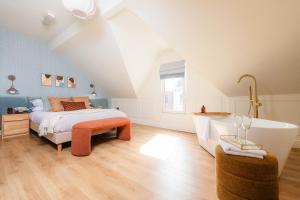 a bedroom with a bed and a bath tub at Coastal Location - Sleeps 6 & Pet Friendly in Bangor