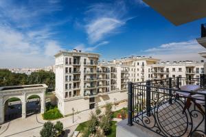 an apartment balcony with a view of buildings at Boulevard 115 in Tashkent