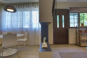 a living room with a table and a door at Modern near the sea-Sunset View Apartments in Ixia