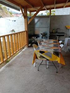 a table in a screened in porch with at Pomme de Pin in Cilaos