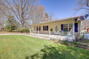 a yellow house with a lawn in front of it at Tracy City Home Near South Cumberland State Park! in Monteagle