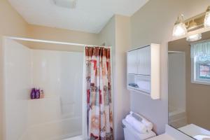 a bathroom with a shower curtain and a toilet at Tracy City Home Near South Cumberland State Park! in Monteagle +16 photos
