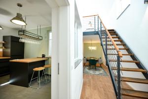 a staircase leading up to a kitchen and a living room at Ferienloft 'Weinstube Fridrich' in Bad Dürkheim