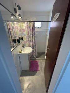 Un baño pequeño con lavabo y espejo. en Cómo en casa, en Resistencia