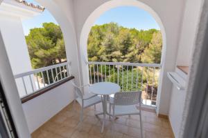 a room with a balcony with a table and chairs at BQ Cala Ratjada in Cala Ratjada