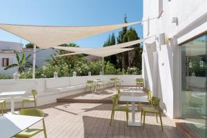 a patio with tables and chairs on a building at BQ Cala Ratjada in Cala Ratjada