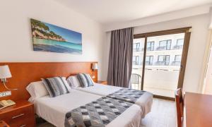 a hotel room with a bed and a large window at R2 Veronica in Cala Millor