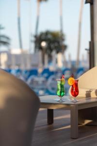 two cocktails sitting on a table on a table at R2 Veronica in Cala Millor +32 photos