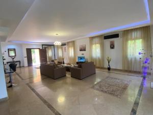 a large living room with couches and a television at Modern Villa in Madinaty