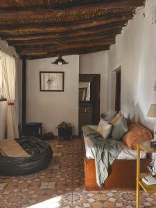 a living room with a bed and a tire at Huaco Casa de Campo in Belén