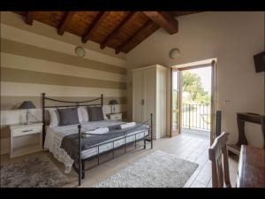 a bedroom with a bed and a sliding glass door at B&B Ronco degli Ulivi in Iseo