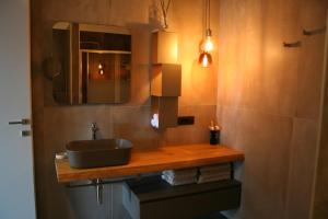 a bathroom with a sink and a mirror at ferienwohnungkarlena in Cerro Lago Maggiore +7 photos