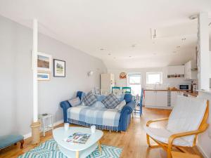 a living room with a bed and a table at Victoria House in Rhosneigr