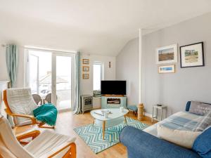 a living room with a couch and a tv at Victoria House in Rhosneigr