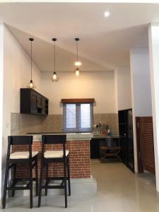 a kitchen with two chairs and a table in a room at Suweg guest house 3 bed room in Amed