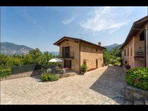 a building with a patio in front of it at B&B Ronco degli Ulivi in Iseo