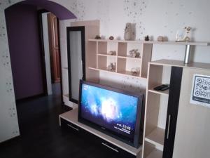 a tv sitting on a stand in a room at Трешка микрорайон Саулет 11 in Qyzylorda