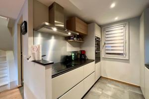 a small kitchen with a sink and a stove at Lachat 15 in Mussillon