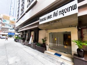 a building with a sign on the side of it at The Key Bangkok Hotel in Bangkok