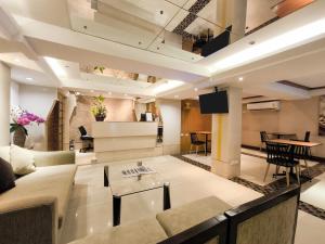 a living room with a couch and a table at The Key Bangkok Hotel in Bangkok