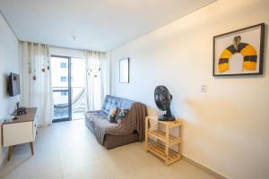 a living room with a couch and a table at Park Del Prado #205 - Apê em Cabedelo by Carpediem in João Pessoa +27 photos