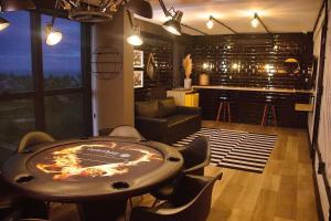 a room with a table and chairs and a bar at Park Del Prado #205 - Apê em Cabedelo by Carpediem in João Pessoa