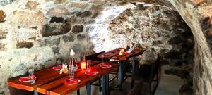a group of tables in a stone walled restaurant at Erlebnishof Steinkellnergut in Henndorf