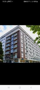 a large apartment building with a large building at Lena_Lux in Jagodina