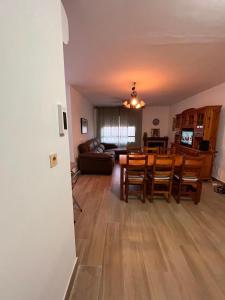 a dining room and living room with a table and chairs at Casa Costacabana Mar in La Cañada de San Urbano +22 photos
