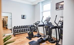a gym with treadmills and ellipticals in a room at Hotel Atlantic Hamburg, Autograph Collection in Hamburg