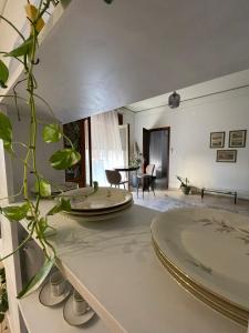 a living room with a table with plates on it at B&B Domus Flora in Reggio Calabria